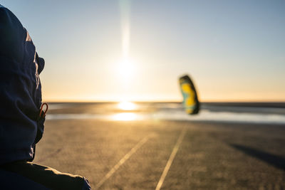 Woman kiteboarding at beach against clear sky