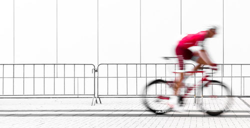 Blurred motion of man riding bicycle