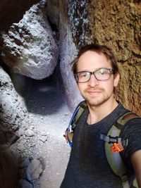 Portrait of young man wearing eyeglasses and rock