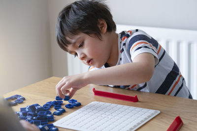 Boy playing with toy at home