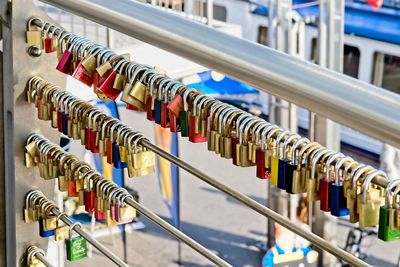 Close-up of padlocks hanging on railing
