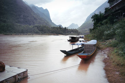 Laotian boats moored on riverside in muang ngoy village