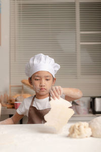 Portrait of boy with ice cream in kitchen