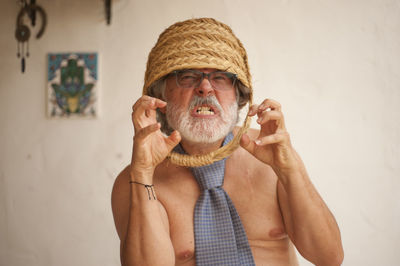 Portrait of man holding hat