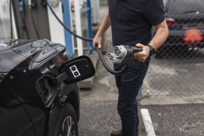 Man charging electric car