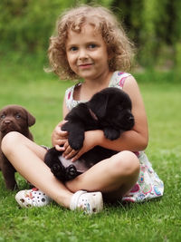 Portrait of cute girl sitting on grass