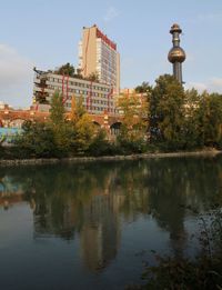 Reflection of trees and buildings in lake