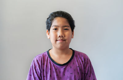Portrait of cute boy against white background