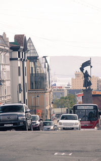 Traffic on road against buildings in city