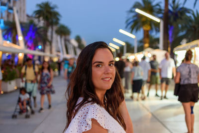 Portrait of pretty girl in busy street in split, croatia on a summer evening