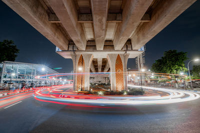 View of light trails on road at night