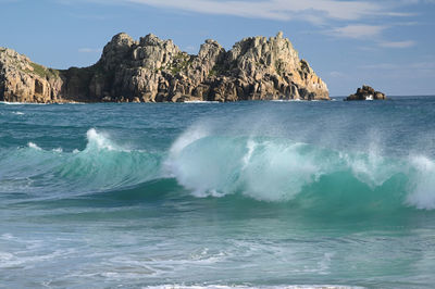 Scenic view of rocks in sea against sky