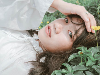 Close-up portrait of a woman lying down