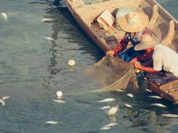 Man and woman fishing at lake