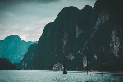 Scenic view of sea and mountains against sky