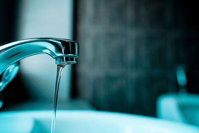 Close-up of faucet in bathroom