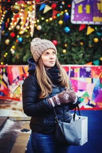 Portrait of young woman in city