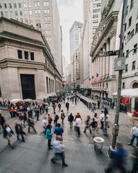 High angle view of people walking on street amidst buildings in city