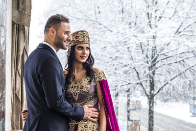 Young couple standing in snow