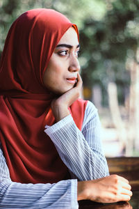 Portrait of young woman standing outdoors