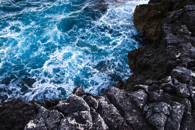 High angle view of rocks in sea