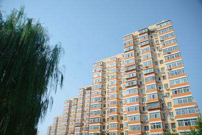 Low angle view of buildings against blue sky