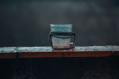 Close-up of glass on wet table during rainy season