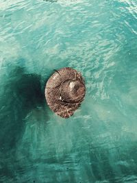 Sun hat floating in blue water 