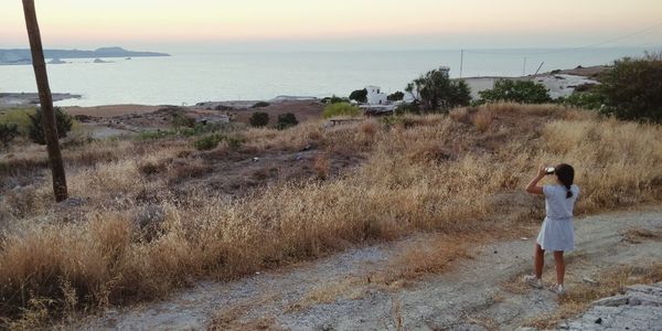 Full length of man standing on beach against sky