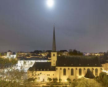 Illuminated buildings against sky at night