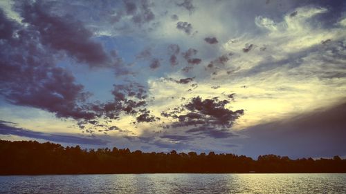 Scenic view of trees against sky during sunset