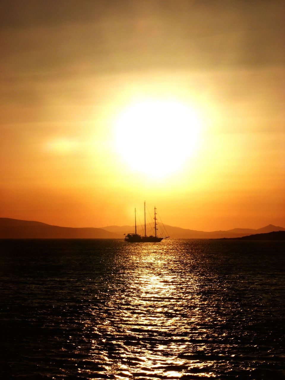 sunset, sea, water, sun, waterfront, scenics, tranquil scene, orange color, tranquility, beauty in nature, silhouette, rippled, nature, sky, horizon over water, idyllic, nautical vessel, sailboat, transportation, boat