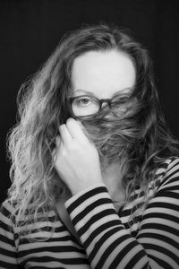 Portrait of beautiful woman against black background