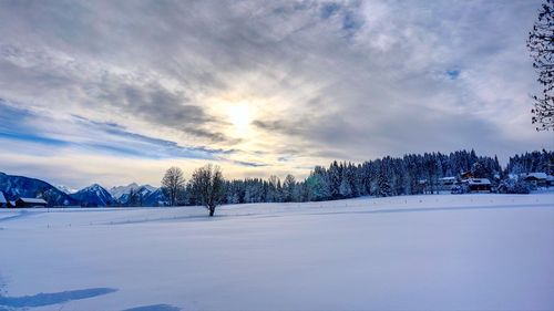 Scenic view of snow covered landscape against sky