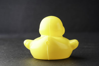 Close-up of yellow toy car on table