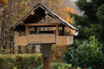 Low angle view of birdhouse on house against sky