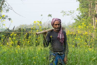 Portrait of man standing in field