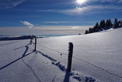 Scenic view of snow covered land against sky