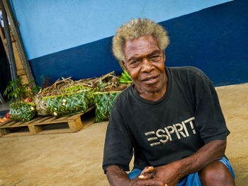 Portrait of a young man sitting outdoors