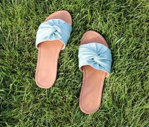 Close-up of slippers on field