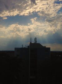 Built structure against cloudy sky at sunset