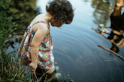 Side view of woman walking in water