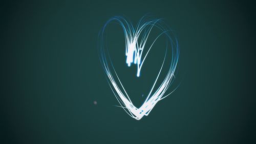 Close-up of illuminated heart shape against black background