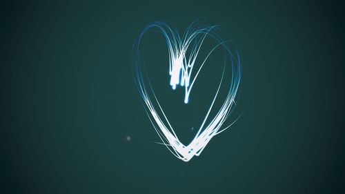 Close-up of illuminated light painting against black background