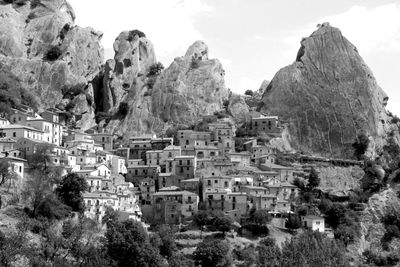 High angle view of old town on rocky mountains against sky