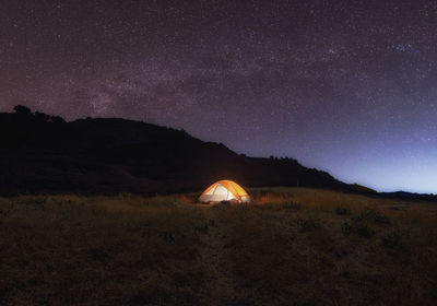 Tent on field against sky at night