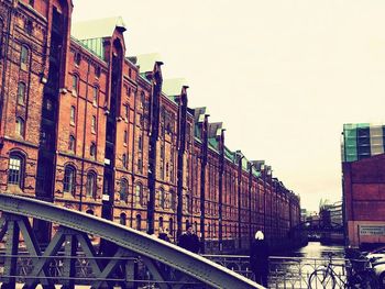 Bridge in city against sky