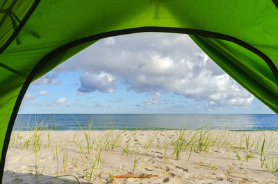 View from the tent on the seashore. hiking tent on the beach. baltic coast and quiet sea.