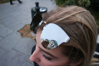 Close-up of woman wearing sunglasses in city