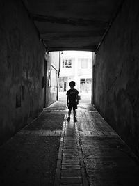 Boy standing in tunnel